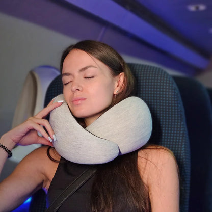 Neck Support travel pillow worn by woman sleeping in airplane seat — grey